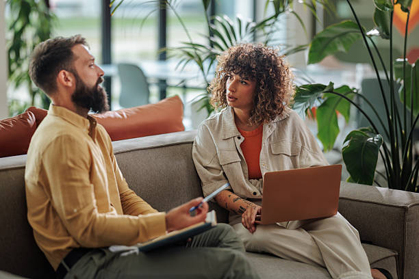 istock Business partners discussing new project in modern office lobby 2217889276