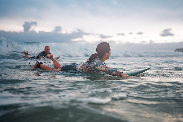 istock Energetic Surfing Couple Riding Waves at Gold Coast Beach 2217890190