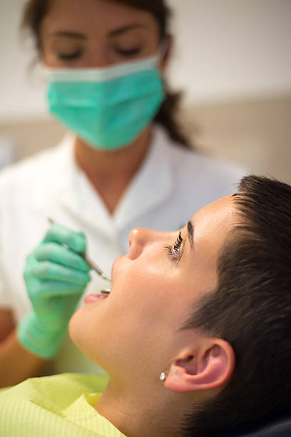 istock Young woman at the dentist 2217897001