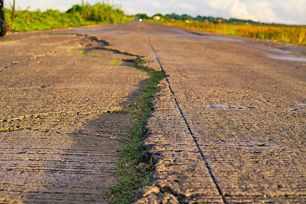 Close Up View Of Cracked Road Surface In Rural Area
