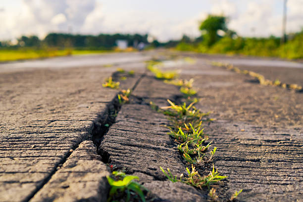 Close Up View Of Cracked Road Surface In Rural Area