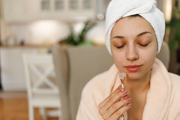 istock Woman enjoying face massage at home 2217900620