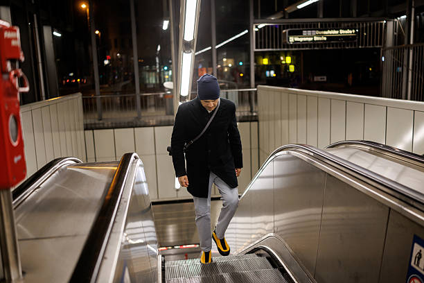 istock Male commuter on subway escalator in the evening 2217902444