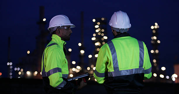 istock Industrial engineer and mechanical engineer with green reflective safety jacket and PPE working at rear car on night shift 2217906228