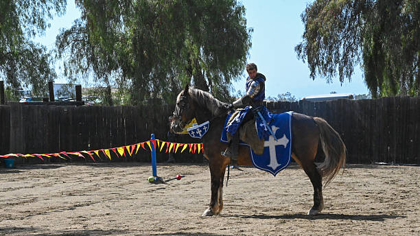 Two medieval knights jousting.