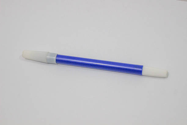 istock A single blue marker with white caps on both ends, lying horizontally on a white background, captured in a close-up view. 2217908305