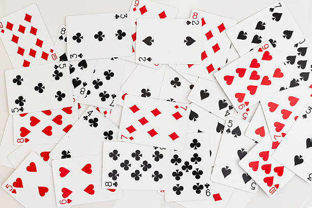 istock Scattered playing cards with mixed suits and numbers on white background 2217908326