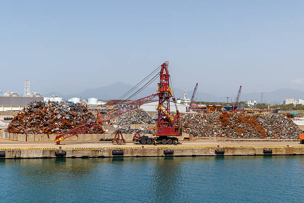 Setubal, Portugal, August 22, 2025, Industrial crane loading scrap metal at sapec solids terminal in the port of setubal, portugal