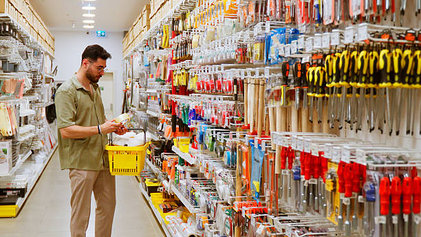 Young Man Shopping in Housewares Aisle of Retail Store stock photo