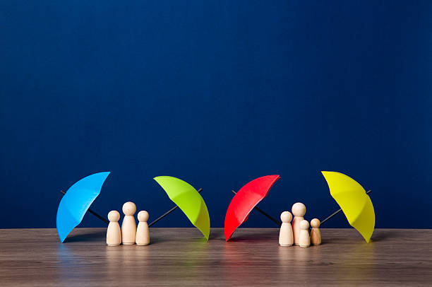istock Umbrella and wooden doll figures. 2217920497