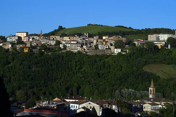 istock village on wooded hill against sky 2217921844