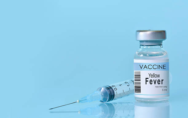 istock Vaccine in a bottle with a syringe on a blue background.The conc 2217923677