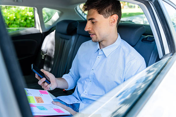 istock Businessman working in the back seat 2217923862