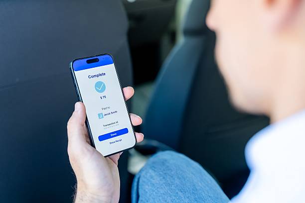 istock Person Using Mobile Payment App in Car 2217923998