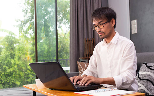 istock man using laptop with searching job and work from home 2217926152