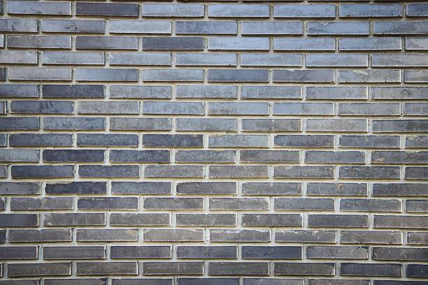 The texture of the brick wall is dark gray