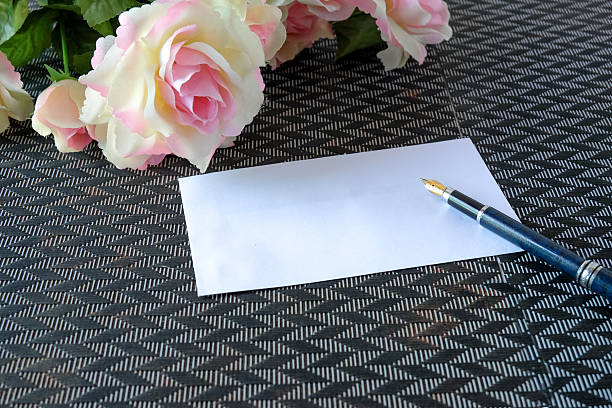 Pink rose flowers with white card on background.