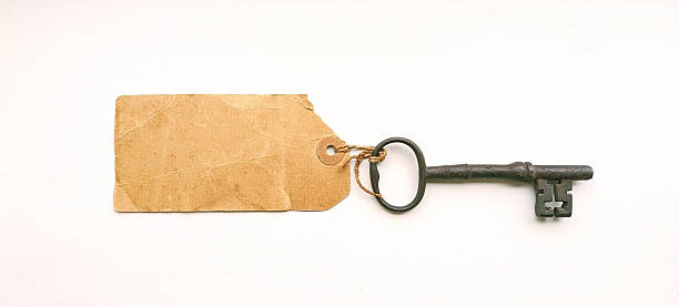 istock Large old key with a blank paper label tied on 2217930198