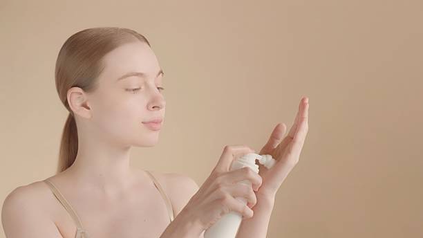 istock Woman applying skincare foam on hand for selfcare routine. Copy space 2217931259