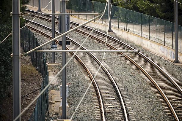Zurich  with a larg track field from the federal rail sevice company SBB. The wide angle image shows the large trackfield with a train approaching on Zurich Mainstation. The image was captured during summer season.