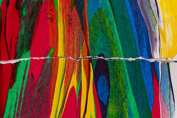 istock Colorful painting on torn paper 2217932467