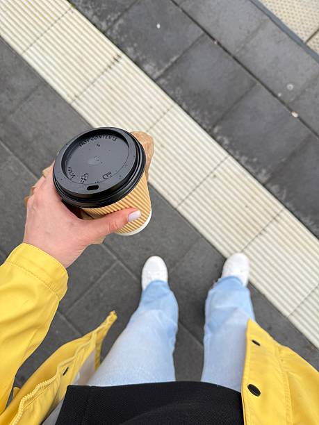 istock Woman holding coffee while waiting at train station 2217932700