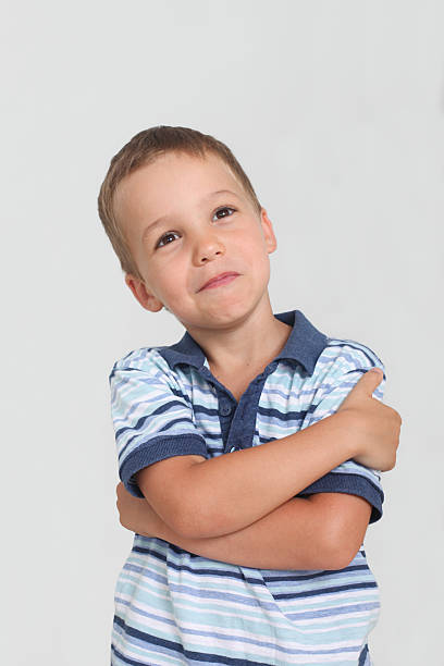 istock contemplating  cute little boy  looking up. 2217932948