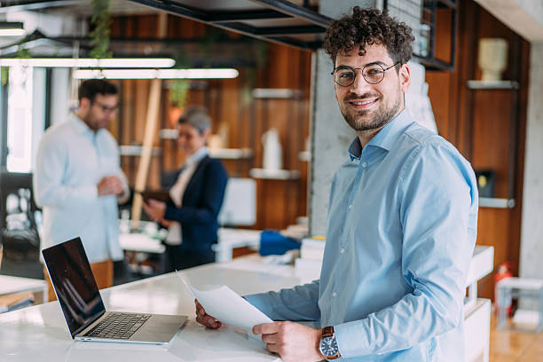 istock Successful businessman in modern office working on laptop. 2217933597
