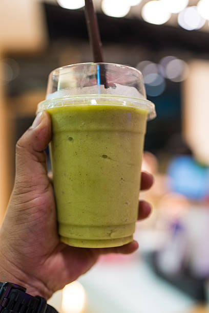 istock Avocado smoothie in glass on hand 2217933743