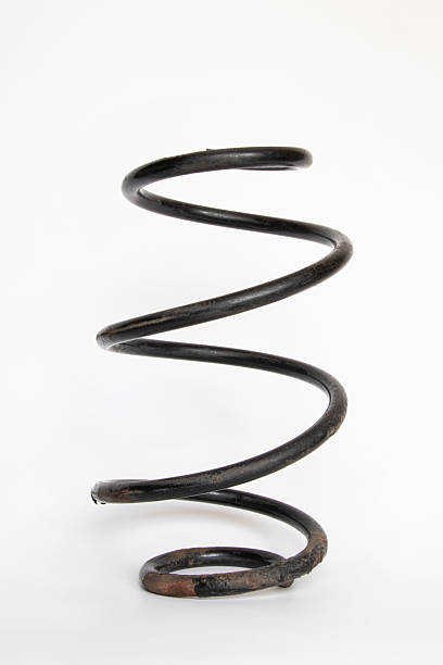 Worn out car suspension spring close-up on white background, replacement, repair, depreciation, car service and suspension parts theme