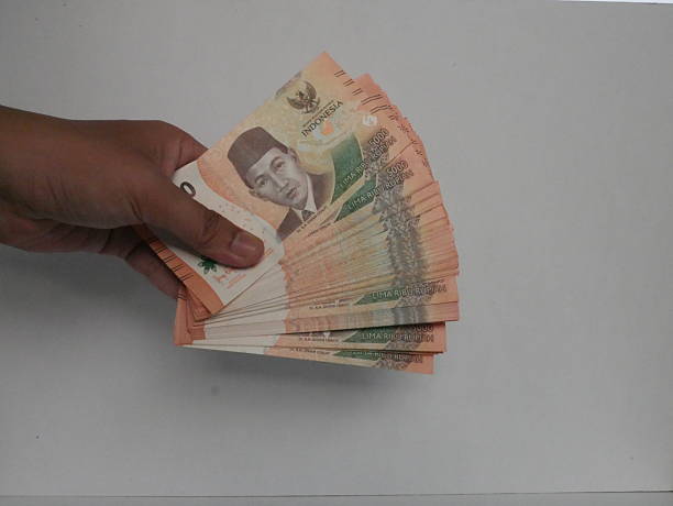 istock A person’s hand gripping an IDR 5,000 banknote 2217936739