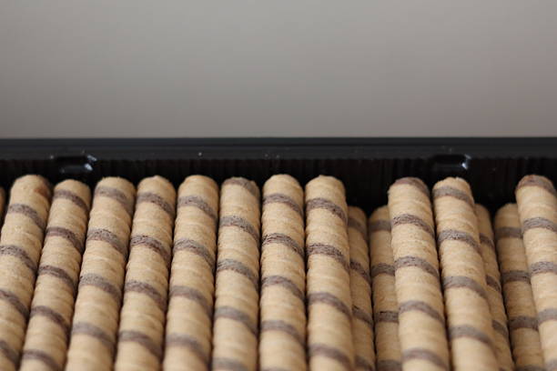 istock Cylindrical rolled pastries arranged neatly in a black tray ready for serving 2217938626