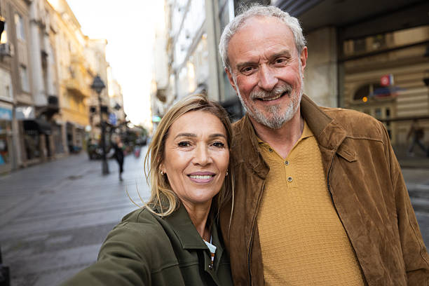 istock Happy senior couple taking selfie while sightseeing in city 2217941087
