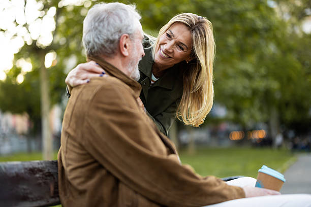 istock Happy senior couple enjoying time together on park bench 2217941114