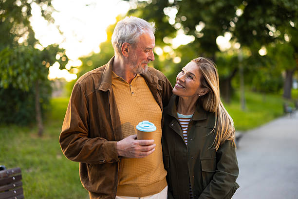 istock Happy senior couple walking and talking in a park 2217941146