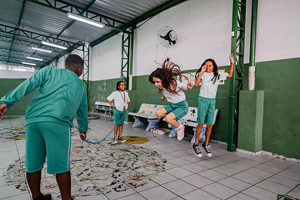 istock School children having fun jumping rope on the courtyard at school 2217943681