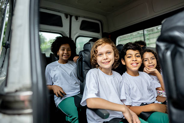 istock Portrait of elementary students inside of school van 2217944908