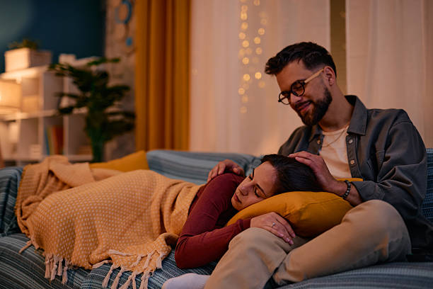 istock Man taking care of his sleeping girlfriend on the sofa 2217946937