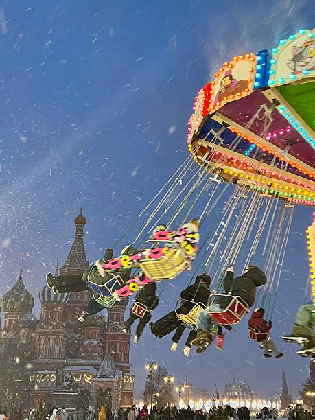 sevilla, spain april 20, 2024: people walking and riding on the rides of the sevilla fair, calle del infierno