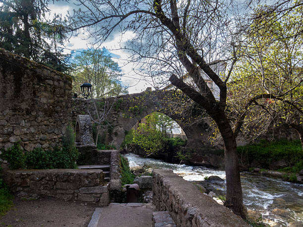 istock Medieval stone bridge crossing a river in a small spanish town 2217948320