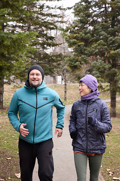 istock Multicultural couple running in public park. 2217948444