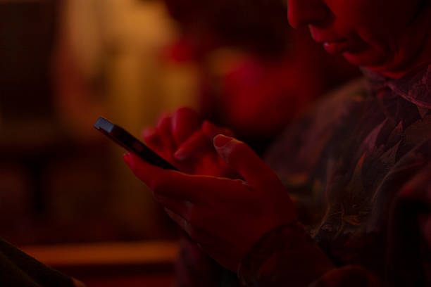 istock A person is engaged in using a smartphone in a low light environment 2217950955