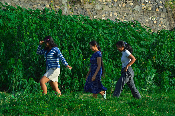 istock Girls jogging lightly through wild green vegetation 2217951414