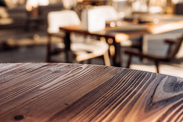 istock Rustic wooden table in bright cafe environment with soft lighting and blurred background 2217951591