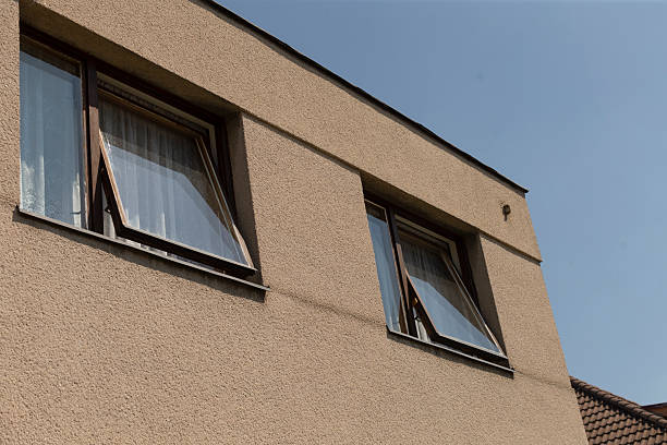 istock There are two open windows positioned on a beige exterior wall of a building 2217952969