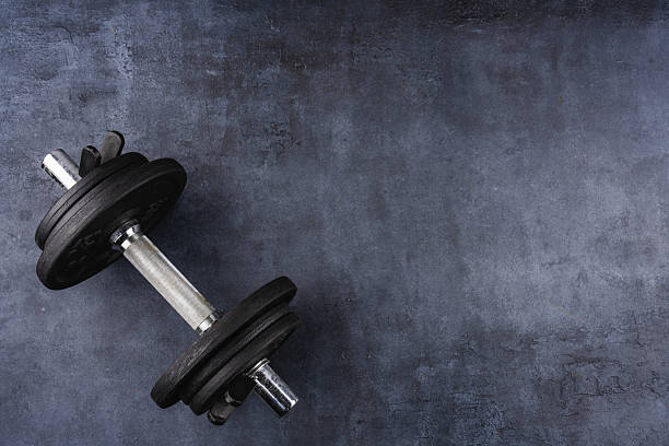 istock Black metal dumbbells on black background 2217955580