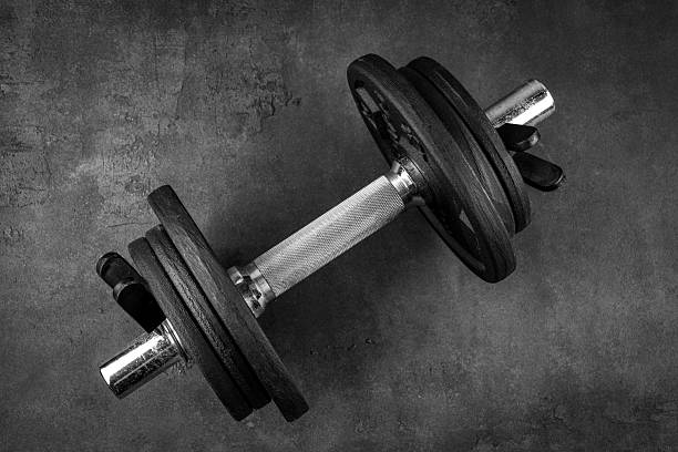istock Black metal dumbbells on black background 2217955623