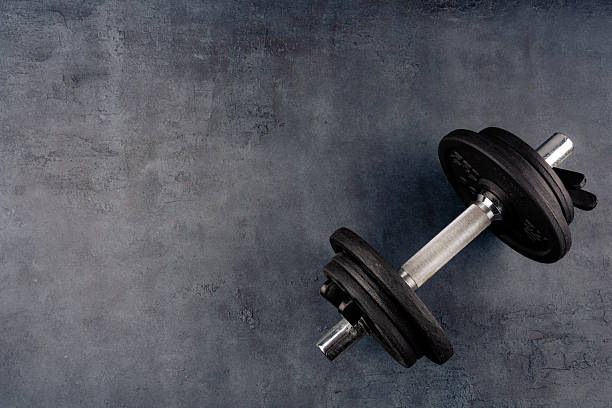 istock Black metal dumbbells on black background 2217955625