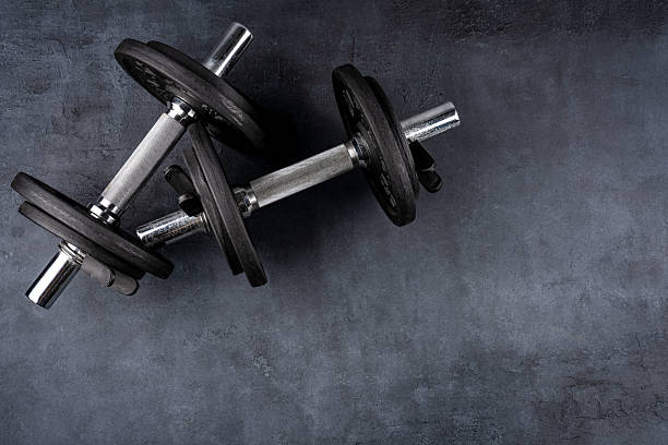 istock Black metal dumbbells on black background 2217955657