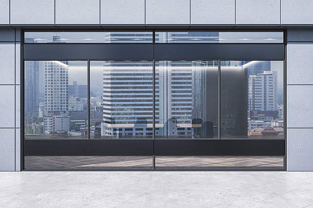 istock Modern office glass facade with cityscape reflection and conference room interior in daylight on concrete wall background. 3D Rendering 2217957769
